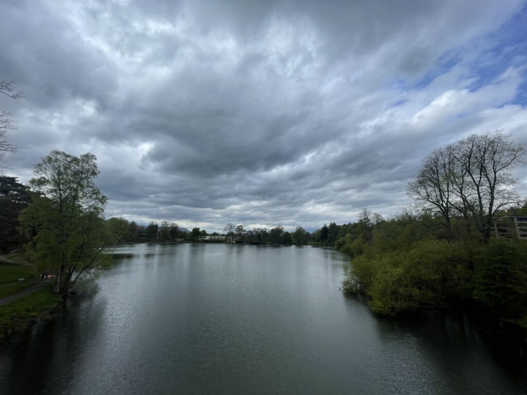 A photograph of the Loch on the University of Stirling Campus, with overcast grey sky.